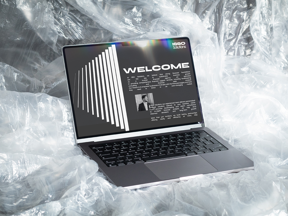 ISSO Solutions corporate website displayed on MacBook laptop screen with professional welcome page design