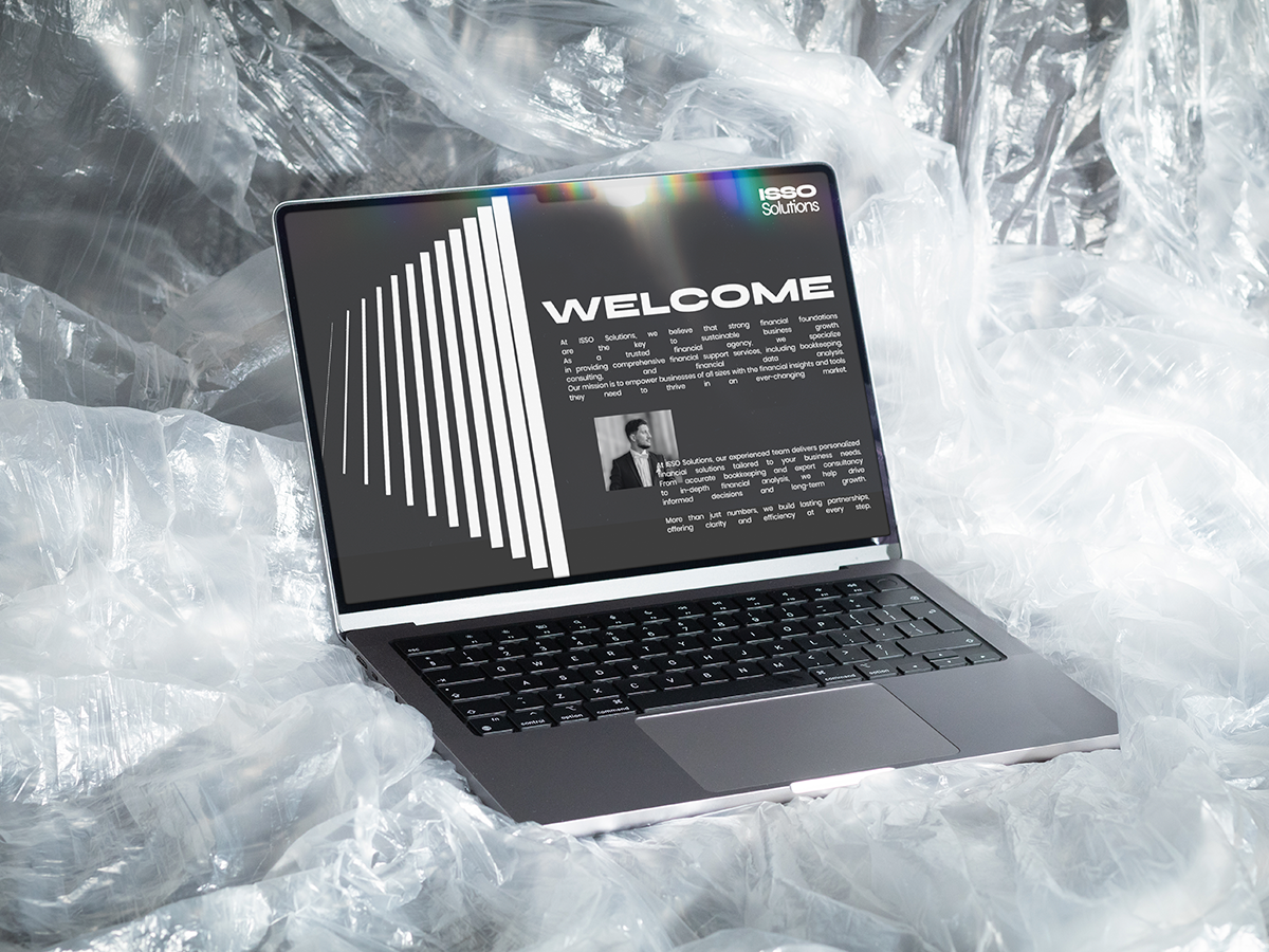 ISSO Solutions corporate website displayed on MacBook laptop screen with professional welcome page design
